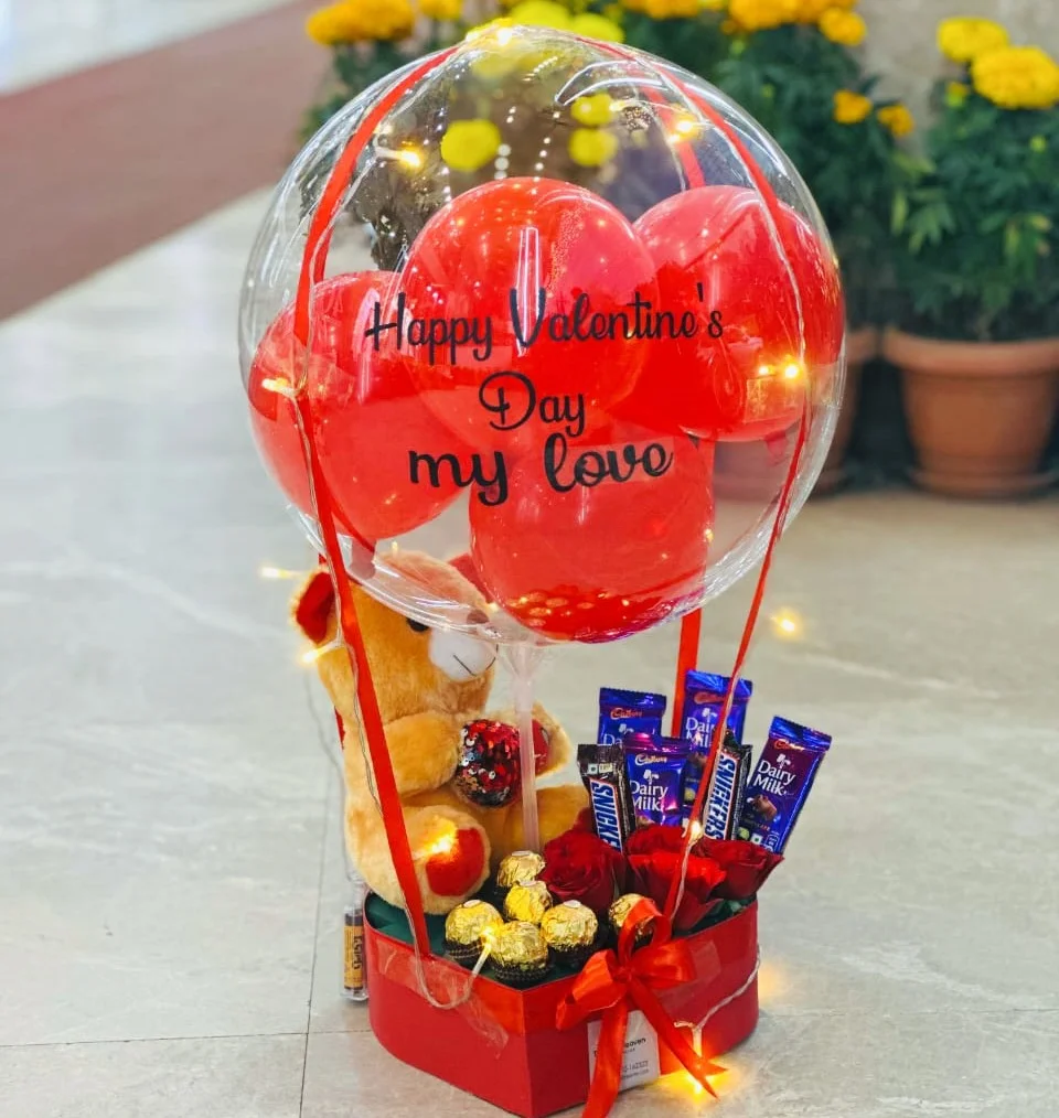 Valentine balloon gift box with chocolates doll red roses and fairy lights by The Gift Heaven