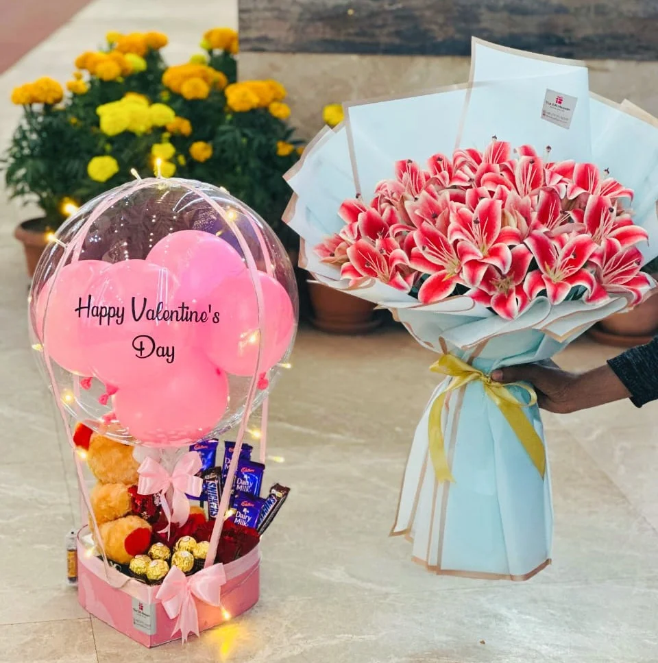 Premium balloon bouquet with artificial lily flowers, chocolates, teddy doll and fairy lights by The Gift Heaven