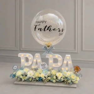 Elegant Father’s Day LED letter arrangement featuring illuminated "PAPA" letters, customized Father’s Day bubble balloon, premium white floral arrangement, and decorative Father's Day accents.