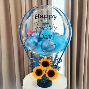 Father’s Day sunflower balloon arrangement featuring a customized Father's Day balloon, blue balloon accents, fresh sunflowers, and elegant floral decoration in a premium display box.