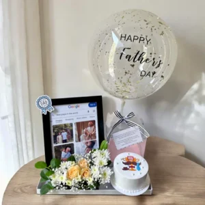 Father’s Day gift arrangement featuring a personalized photo frame, customized Father’s Day bubble balloon, mini celebration cake, floral decoration, and premium display tray.