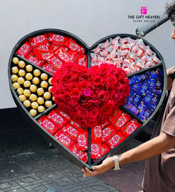 Luxury giant heart-shaped chocolate gift box with fresh red roses, Ferrero Rocher, KitKat, Raffaello, and Cadbury Dairy Milk chocolates, handcrafted by The Gift Heaven for romantic occasions in Bangladesh.