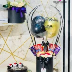 Luxury birthday hot air balloon chocolate gift box with premium balloons, KitKat, Cadbury Dairy Milk, Ferrero Rocher chocolates, elegant floral arrangement, and black luxury gift box by The Gift Heaven Bangladesh.
