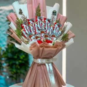 Luxury Kinder Bueno chocolate bouquet with premium wrapping, red roses, decorative greenery, and elegant white ribbon, handcrafted for birthdays, anniversaries, Valentine's Day, and special occasions in Bangladesh.