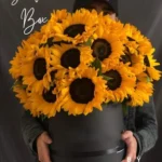 Luxury sunflower flower box featuring premium fresh sunflowers elegantly arranged in a stylish black round gift box, perfect for birthdays, congratulations, anniversaries, and special occasions in Bangladesh.