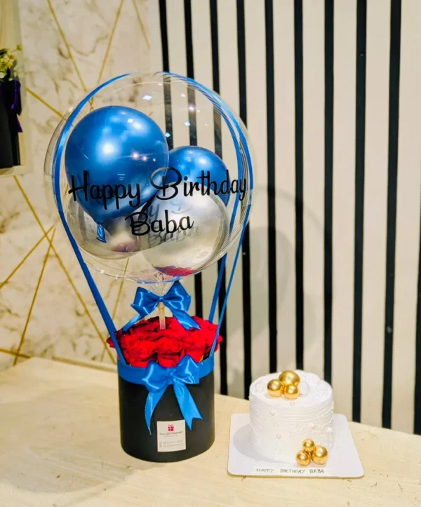 Luxury Happy Birthday Baba gift set with hot air balloon arrangement, fresh red roses, premium white birthday cake, and elegant blue-themed decoration by The Gift Heaven Bangladesh.