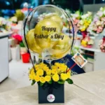 Luxury Father's Day hot air balloon flower box with premium gold balloons, fresh yellow roses, elegant black gift box, and personalized Father's Day decoration by The Gift Heaven Bangladesh.